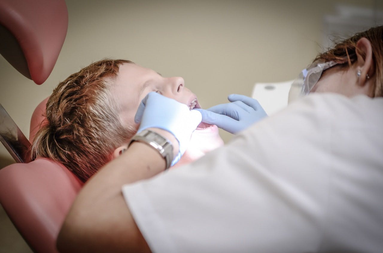 dentist looking in patient's mouth